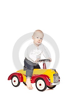 Boy riding his toycar