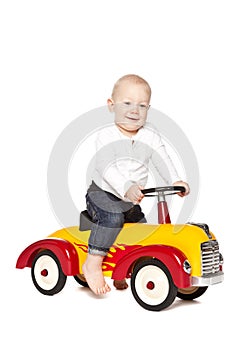 Boy riding his toycar