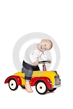 Boy riding his toycar photo