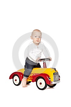 Boy riding his toycar