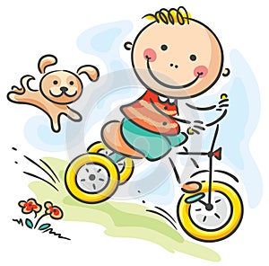 Boy riding his tricycle photo