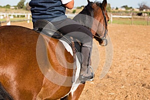 Boy riding a horse in the ranch