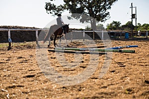 Boy riding a horse in the ranch