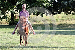 Boy riding pony horse