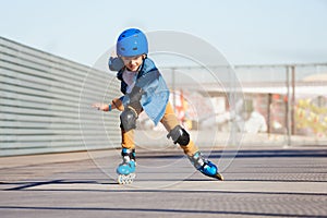 Boy riding on roller skates at outdoor skate park