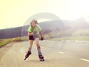 boy riding on rollers on the road