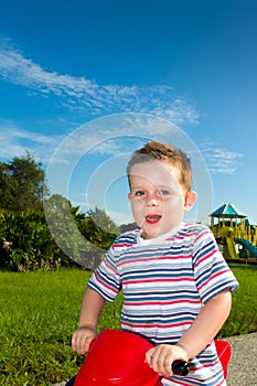 Boy riding on a toy motorbike