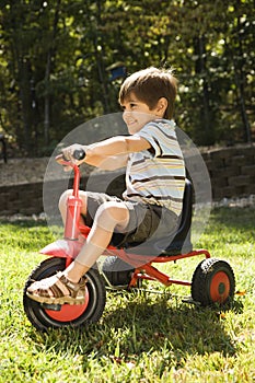 Boy riding tricycle. photo