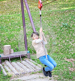 Boy riding a zip line