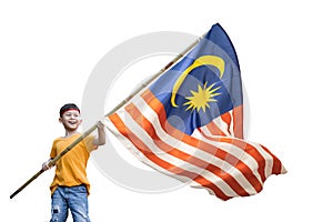 Boy rising malaysian flag with pride