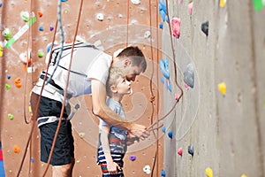 Boy rock climbing photo