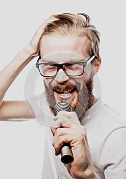 Boy Rocking Out. Image of a handsome bearded man singing to the microphone.