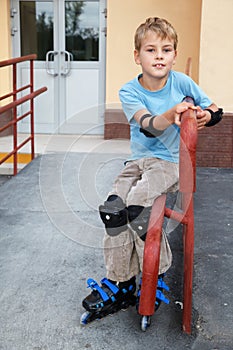 Boy in rollerblades, knee and elbow pads photo