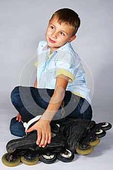 Boy in rollerblades sitting