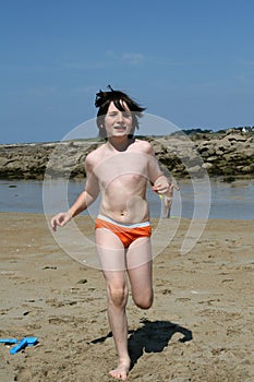 Boy running on beach