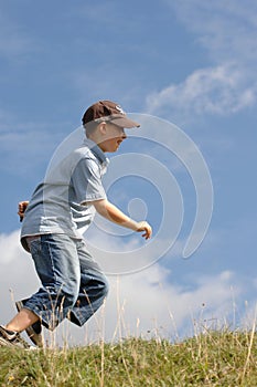 A boy running in grass