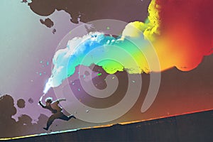 Boy running and holding up colorful smoke flare on dark background