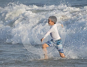 Boy running in the ocean
