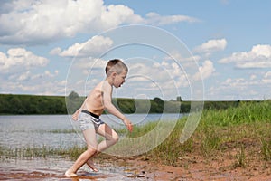 A boy running out of the river