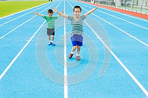 Boy running on racetrack