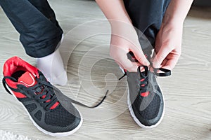 The boy running shoes laces