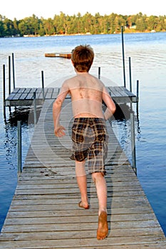 Boy running to the lake