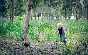 Boy running in the woods