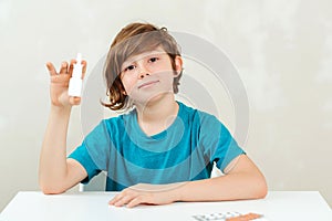 Boy with runny nose using nasal medicine spray. Nasal allergy. Kid with ill disease treatment season. Allergic kid, flu season