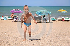 Boy runs on a beach