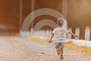 The boy runs by the lake in the forest