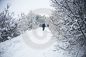 The boy runs through the snow.