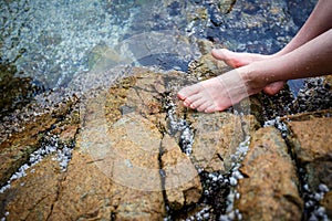 Boy's bare feet on the rock