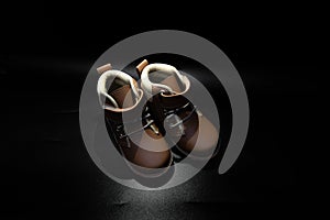 Boy`s boots in nubuck leather isolated on black background, closed