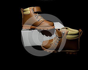 Boy`s boots in nubuck leather isolated on black background, closed