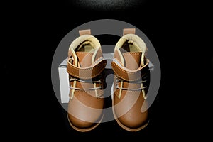 Boy`s boots in nubuck leather isolated on black background, closed