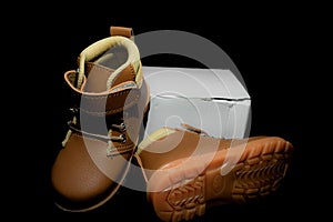 Boy`s boots in nubuck leather isolated on black background, closed