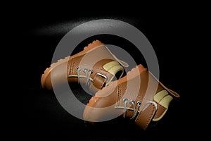 Boy`s boots in nubuck leather isolated on black background, closed