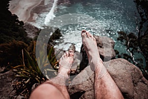 boy& x27;s feet dangling over new chums beach