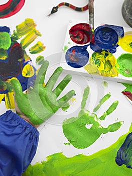 Boy's Hand Finger Painting In Class