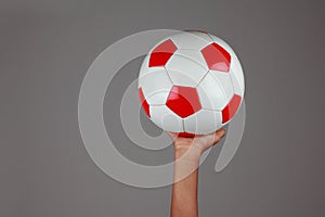 A football in a boy`s hand