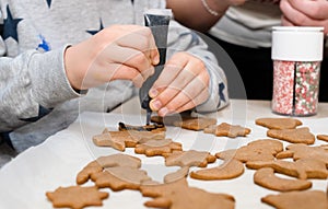 The boy& x27;s hands make Christmas cookies. The little cook.