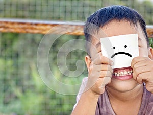 A boy with sad expression icon on paper.