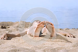 Boy in sand on seashore