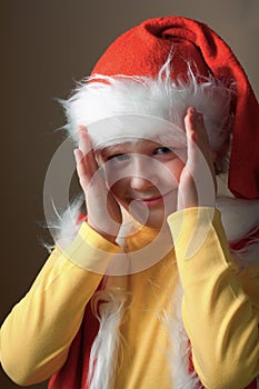 Boy in Santa Claus suit open face.