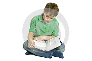 Boy sat reading a book.