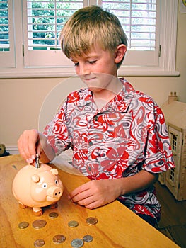 Boy Saving Money Piggybank photo