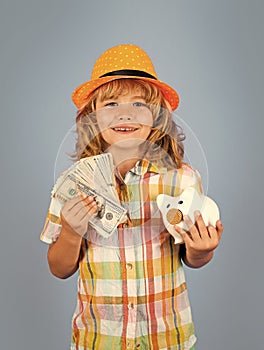 Boy saving money in a piggybank. Child boy with american dollars money. Business, saving and economic.