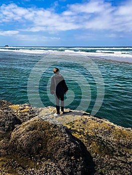 Boy Scanning Sea Horizon for incoming waves