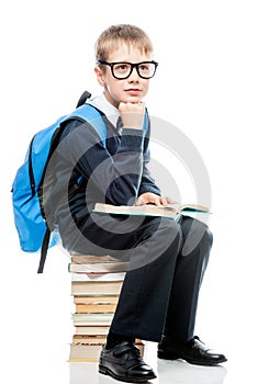 Boy in school uniform with books on a white background