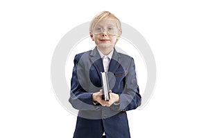 Boy in school uniform and glasses with textbook in his hands in isolation on white background. Excellent student